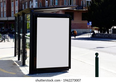 Image Composite Of Bus Shelter. Bus Transit Stop. Blank White Lightbox. Glass Structure. Urban Setting. City Street Background. Asphalt Sidewalk.blank Poster Ad Commercial Space. Background For Mockup