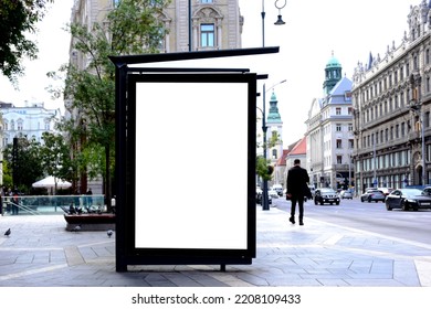 Image Composite Of Bus Shelter. Bus Transit Stop. Blank White Lightbox. Glass Structure. Urban Setting. City Street Background. Stone Sidewalk. Blank Poster Ad Commercial Space. Background For Mockup