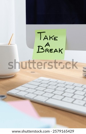 An image of a computer screen on a desk with a sticky note that reads "Take a Break," serving as a gentle reminder to pause, relax, and recharge during work