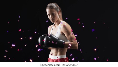 Image of confetti falling over caucasian female boxer on black background. Sports, winning and celebration concept digitally generated image. - Powered by Shutterstock