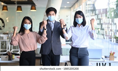Image of confident businesspeople or office worker wearing medical mask while standing in modern office. - Shutterstock ID 1885205200