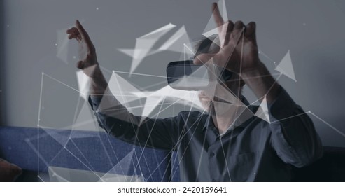 Image of connections and data processing over caucasian businessman using vr headset in office. Global business, finances, computing and data processing concept digitally generated image.