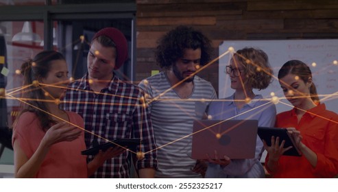 Image of connections and data processing over diverse business people in office. Global finance, business, connections, computing and data processing concept digitally generated image.