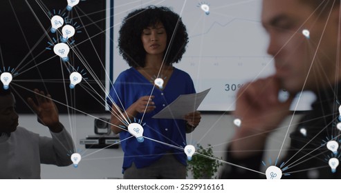 Image of connections, statistics and data processing over diverse business people at meeting. Global business, finance and data processing concept digitally generated image.