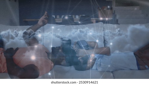 Image of constellations over happy african american father and son wearing vr headsets. family, togetherness, spending quality time concept digitally generated image. - Powered by Shutterstock