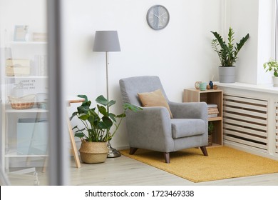 Image Of Cosy Armchair With Flowers In Modern Living Room At Home