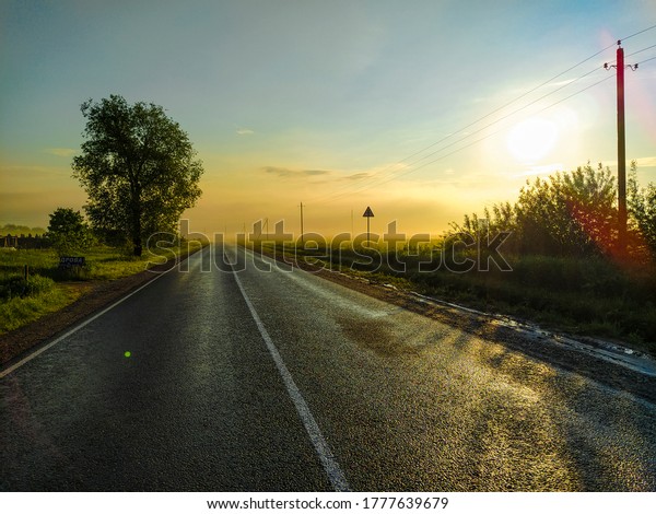 image of a country highway\
at sunset