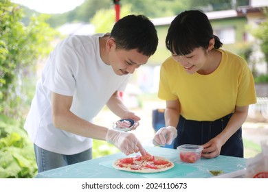 Image Of A Couple Making Pizza By Hand 
