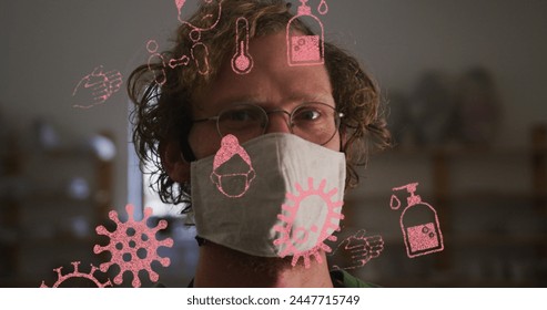 Image of covid 19 icons over man in pottery studio wearing face mask. global covid 19 pandemic concept digitally generated image. - Powered by Shutterstock