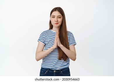 Image Of Coy, Thoughtful Woman Rub Hands And Look With Smug Face At Camera, Scheming, Has An Evil Plan, Stands Against White Background