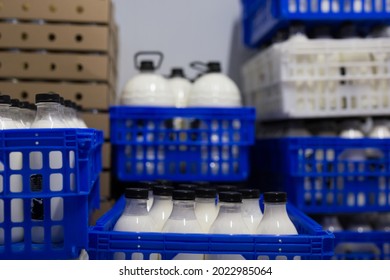 Image of crates of fresh farm cow's milk spilled in plastic bottles