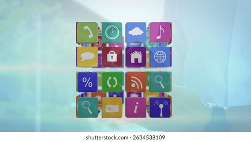 Image of cube with icons over person using smartphone. Global business, finances, digital interface and connections concept digitally generated image.
