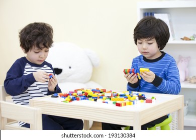 The Image Of Cute Asian Kids Playing Lego