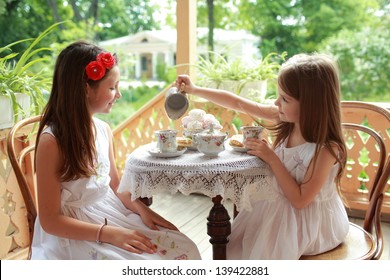 Image of cute little girls with tea - Powered by Shutterstock