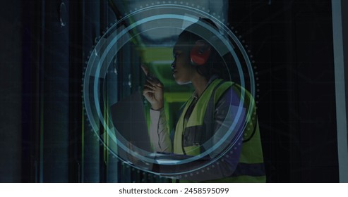 Image of cyber security text, magnifying glass, african american engineer checking data room. Digital composite, laptop, network security, data center, networking, technology, network server.