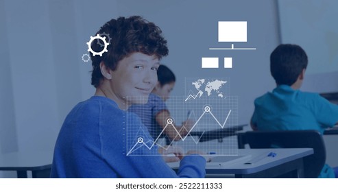 Image of data media icons processing over happy caucasian schoolboy smiling in classroom. Learning, education, data, connection, school and communication, digitally generated image. - Powered by Shutterstock