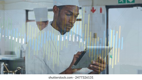 Image of data processing against african american male chef using digital tablet in the kitchen. Modern kitchen cooking concept