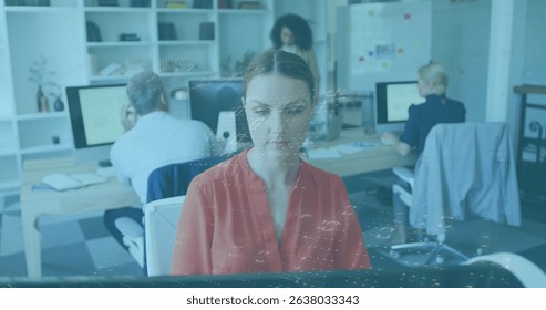 Image of data processing against caucasian woman using computer at office. Computer interface and business technology concept