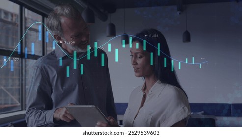 Image of data processing against diverse man and woman discussing over a tablet at office. Computer interface and business data technology concept