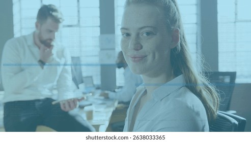 Image of data processing against portrait of caucasian woman smiling at office. Computer interface and business technology concept