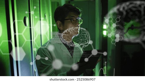 Image of data processing with brains over asian male scientist in server room. Global science, technology, computing and digital interface concept digitally generated image.