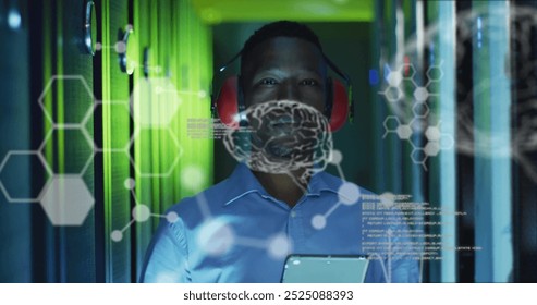 Image of data processing with brains over african american businessman in server room. Global science, technology, computing and digital interface concept digitally generated image.
