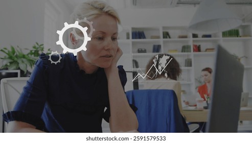 Image of data processing with business icons over diverse colleagues working in office. Global business, finances and digital interface concept digitally generated image.