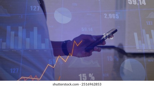Image of data processing and diagrams over biracial man using smartphone. Global business, technology and digital interface concept digitally generated image.