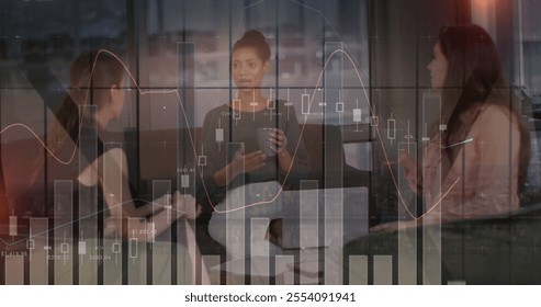 Image of data processing and diagrams over diverse female colleagues talking in office. Business, technology and digital interface concept digitally generated image.