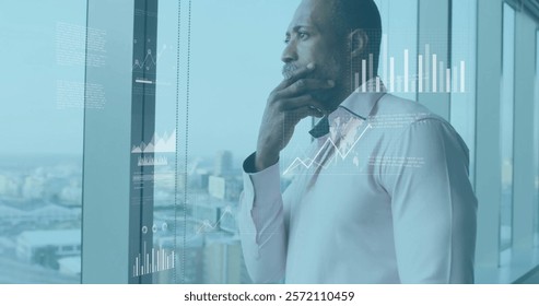 Image of data processing and diagrams over african american businessman thinking. Global business and digital interface concept digitally generated image.