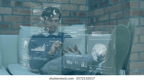 Image of data processing and diagrams over caucasian businessman using tablet. Global business and digital interface concept digitally generated image.