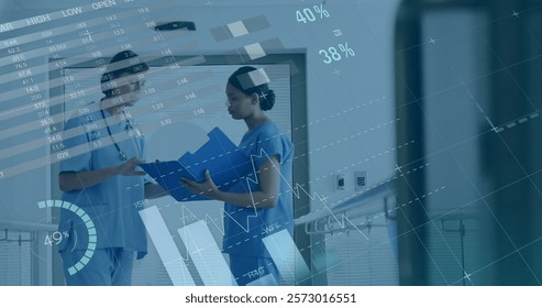 Image of data processing and diagrams over diverse female doctors talking in hospital. Medicine and digital interface concept digitally generated image.