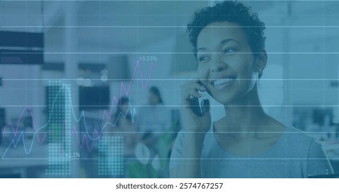 Image of data processing and diagrams over biracial woman talking on smartphone. Technology, business and digital interface concept digitally generated image.