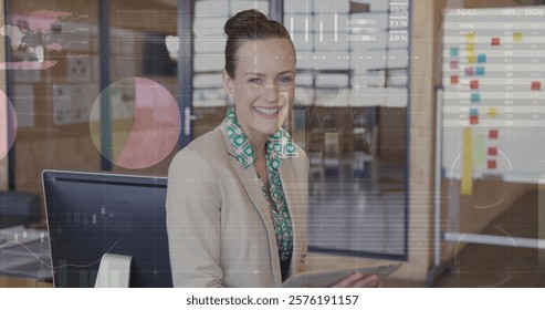Image of data processing and diagrams over caucasian businesswoman using tablet. Technology, business and digital interface concept digitally generated image.