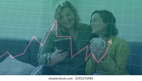 Image of data processing and diagrams over caucasian female couple using tablet at home. Technology, business and digital interface concept digitally generated image.
