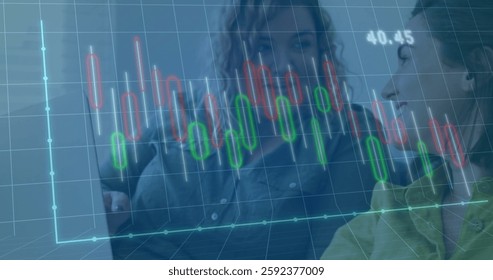 Image of data processing and diagrams over diverse colleagues using laptop in office. Technology, business and digital interface concept digitally generated image.