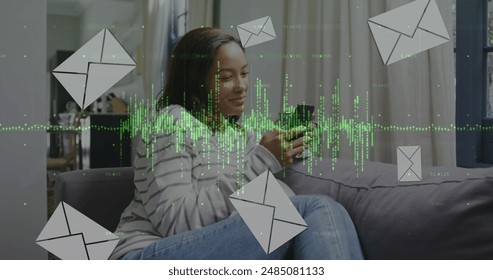Image of data processing and envelopes icons over biracial woman using smartphone. Global business and digital interface concept digitally generated image.