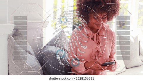 Image of data processing with fingerprint over african american businesswoman using smartphone. Global technology, social media and digital interface concept digitally generated image.