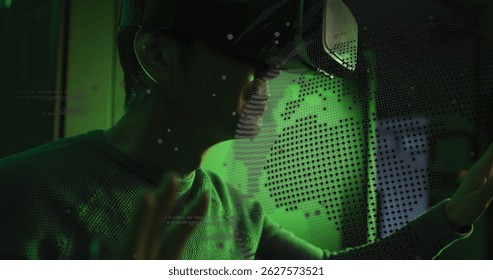 Image of data processing and globe over asian male it technician wearing vr headset. Global computing and data processing concept digitally generated image.