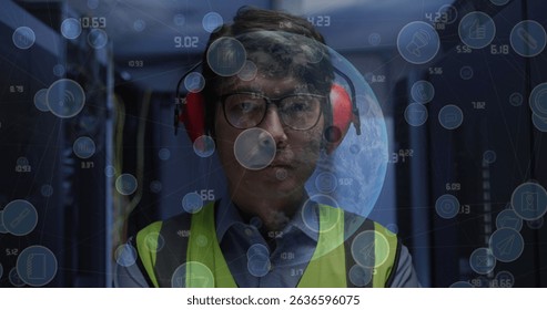 Image of data processing with icons and globe over asian male worker. Global business, computing and digital interface concept digitally generated image.