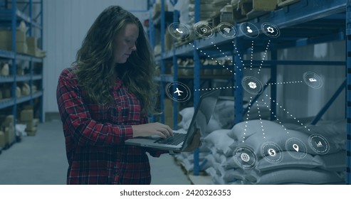 Image of data processing with icons over caucasian woman working in warehouse. Global shipping, networks, digital interface, computing and data processing concept digitally generated image.