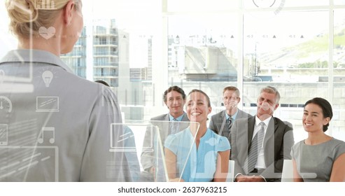 Image of data processing with icons over diverse business people at office. Global business, computing and digital interface concept digitally generated image.