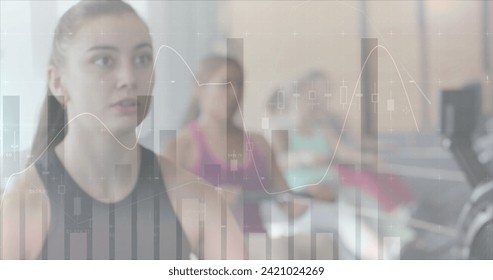 Image of data processing on graph over caucasian woman training on rowing machine at gym. Fitness, exercise, strength, data, digital interface and technology digitally generated image.
