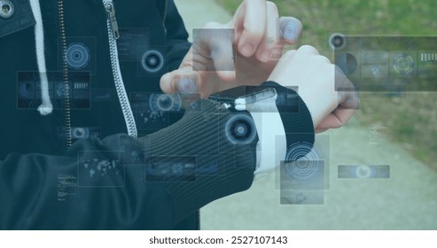 Image of data processing on screens over caucasian man checking smartwatch. Lifestyle, data processing, communication and technology concept digitally generated image. - Powered by Shutterstock