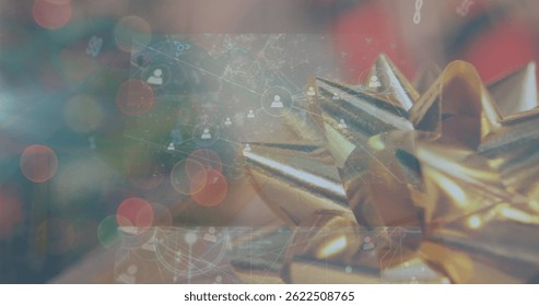 Image of data processing on screens over christmas present. christmas, celebration, data processing and technology concept digitally generated image.
