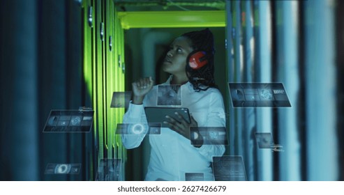 Image of data processing on screens over african american woman working in server room. network, programming, computers and technology concept digitally generated image.