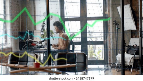 Image of data processing over african american businessman in office. Global finance, business, connections, computing and data processing concept digitally generated image.