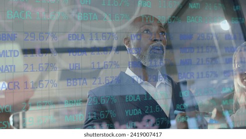 Image of data processing over african american businessman in office. Global finance, business, connections, computing and data processing concept digitally generated image.