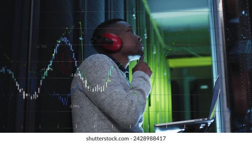 Image of data processing over african american male it engineer and computer servers. Global computing and data processing concept digitally generated image.