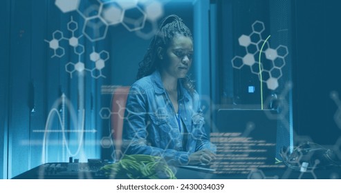 Image of data processing over african american female server room worker using laptop. Cloud computing concept concept digitally generated image.